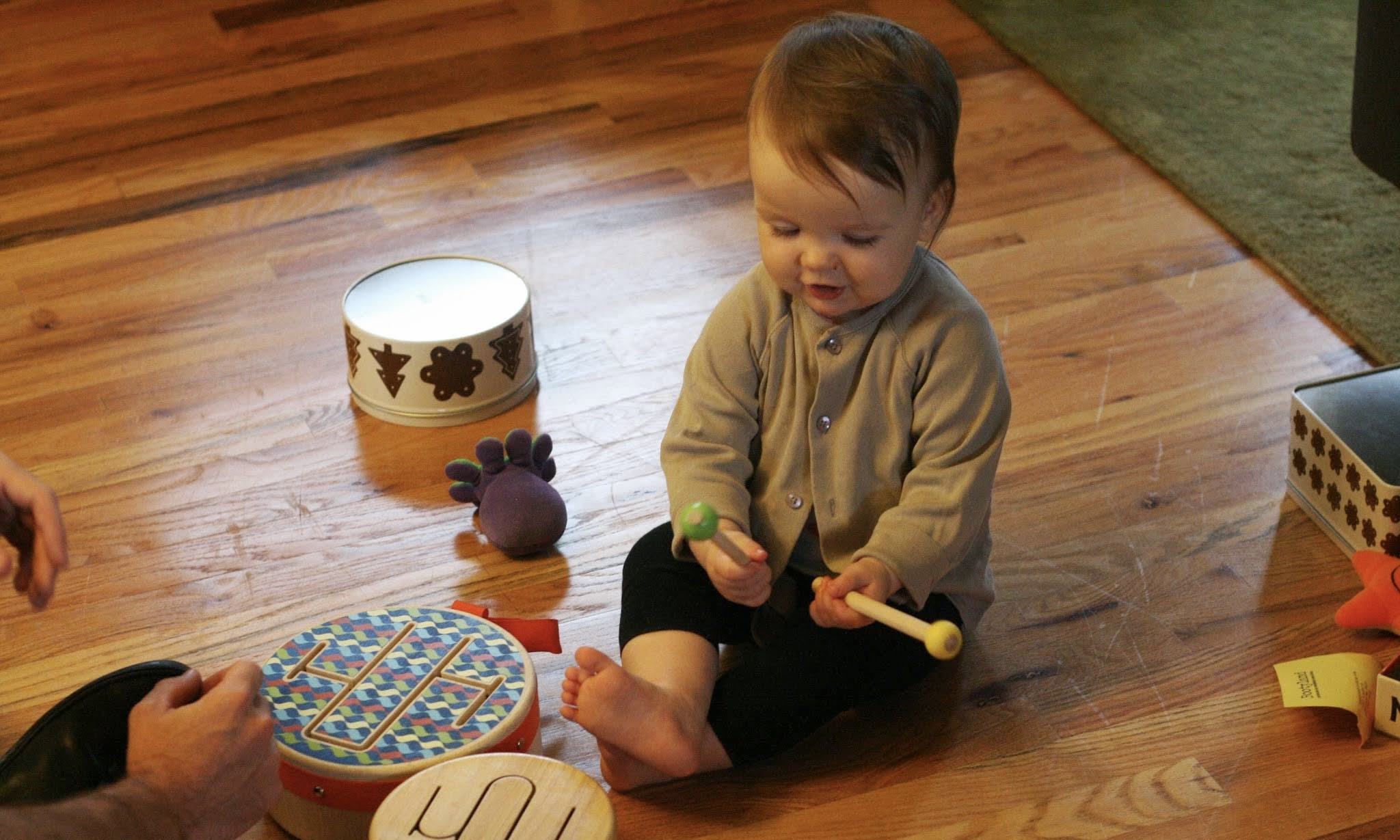 Toddler playing drums in MiniMeter class